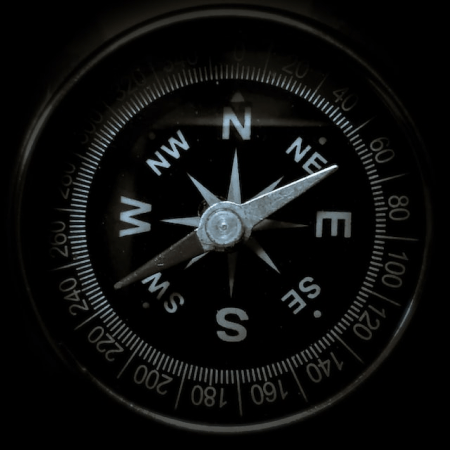 An overhead of a compass with the needle pointing north, hovering over North-east