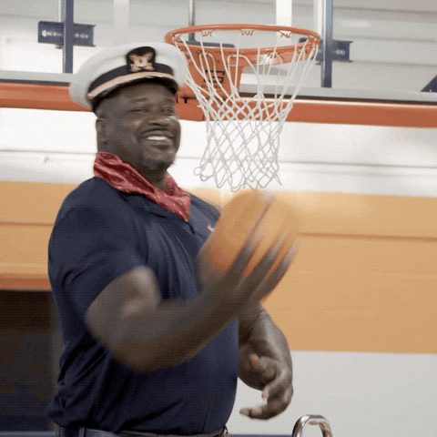 Shaq dressed as a sailor and shooting a ball over his shoulder at the ring and missing